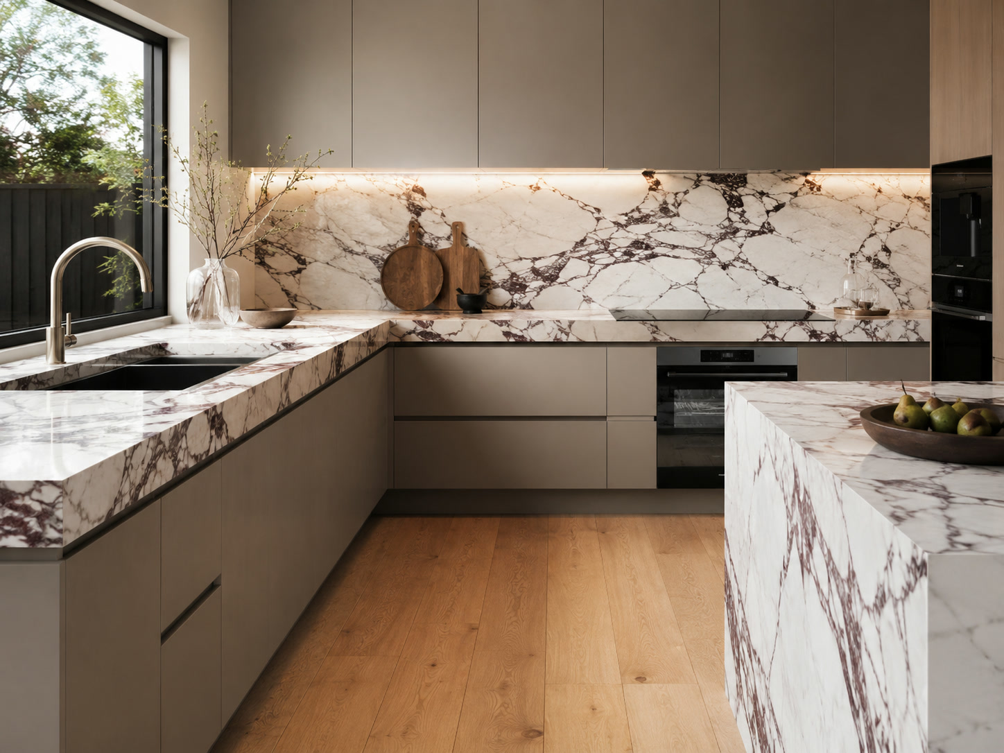 Modern taupe kitchen with dramatic marble benchtops and splashback
